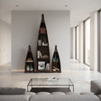 Set of three handcrafted canoe-shaped display shelves in a dark stained wood finish, styled with books, plants, bottles, and decorative accessories to create a striking focal point in a contemporary living space.