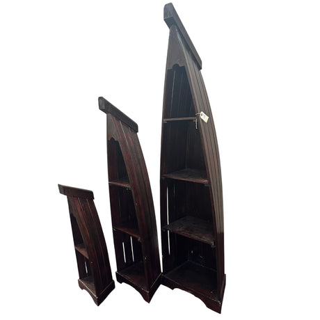 Set of three handcrafted canoe-shaped display shelves in dark stained solid wood, featuring open display compartments in three different sizes, shown together against a white background.