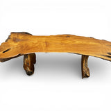 Handcrafted rustic live edge coffee table made from solid natural timber, featuring an organic slab tabletop with sculptural log legs, showcasing rich wood grain and timeless artisan craftsmanship.