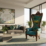 Luxury high-back wingback accent chair featuring a hand-carved dark wood frame, vibrant teal upholstery with an elephant and tropical botanical print, rolled arms, and ornate carved detailing. A bold statement chair for eclectic, luxury, and safari-inspired interiors.