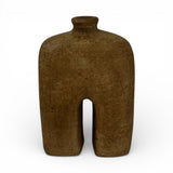 Sculptural stoneware vase with a rich earthy brown finish, featuring a minimalist arched silhouette, narrow neck, and textured handcrafted surface. A modern decorative vase that adds warmth, organic character, and contemporary style to shelves, console tables, coffee tables, or styled interiors.