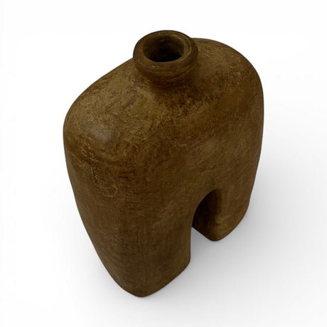 Sculptural stoneware vase with a rich earthy brown finish, featuring a minimalist arched silhouette, rounded shoulders, a narrow neck, and a textured handcrafted surface. An elegant decorative vase that brings warmth, organic character, and contemporary style to shelves, console tables, coffee tables, or styled interiors.