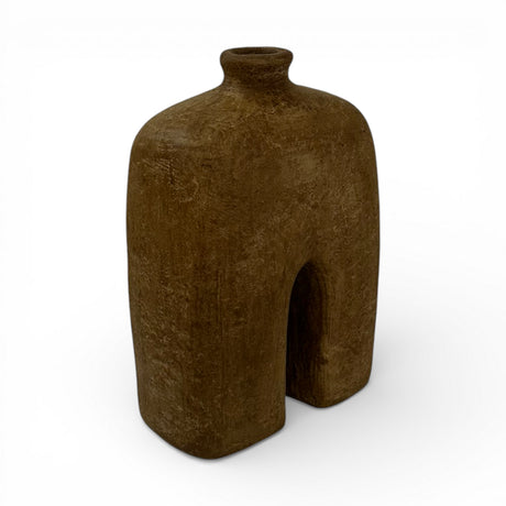 Sculptural stoneware vase with a rich earthy brown finish, featuring a minimalist arched silhouette, rounded shoulders, a narrow neck, and a textured handcrafted surface. A contemporary decorative vase that adds warmth, organic elegance, and sculptural appeal to shelves, console tables, coffee tables, or styled interiors.