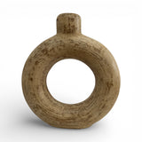 Sculptural stoneware vase with a warm natural finish, featuring a circular cut-out centre, rounded halo silhouette, and short cylindrical neck. A handcrafted contemporary decorative vase that adds organic texture and modern elegance to shelves, console tables, coffee tables, or styled interiors.