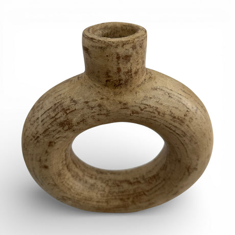 Sculptural stoneware vase with a warm natural finish, featuring a circular cut-out centre, rounded halo silhouette, and short cylindrical neck. A handcrafted contemporary decorative vase that adds organic texture and modern elegance to shelves, console tables, coffee tables, or styled interiors.