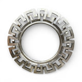 Round decorative wall mirror featuring a brushed silver geometric frame with a bold Greek key-inspired design, creating a sleek contemporary statement piece for modern interiors.