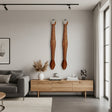 Set of two handcrafted tribal giraffe wall masks featuring elongated carved faces with warm natural wood tones, cream geometric detailing, and hand-painted accents. Inspired by traditional African craftsmanship, these decorative wall sculptures add warmth, texture, and safari-inspired elegance to living rooms, hallways, and feature walls.