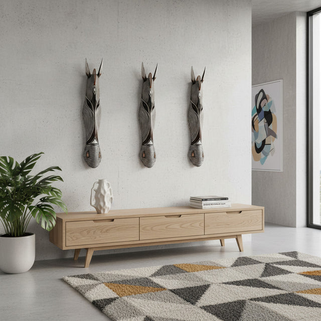 Set of three handcrafted tribal zebra wall masks featuring elongated carved faces with striking black, white, and natural wood detailing. Inspired by traditional African artistry, these decorative wall sculptures add texture, character, and contemporary elegance to living rooms, hallways, and feature walls.