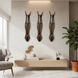 Set of three handcrafted tribal zebra wall masks featuring elongated carved faces with warm amber, black, and natural wood detailing. Inspired by traditional African craftsmanship, these decorative wall sculptures add texture, warmth, and bold character to living rooms, hallways, and feature walls.