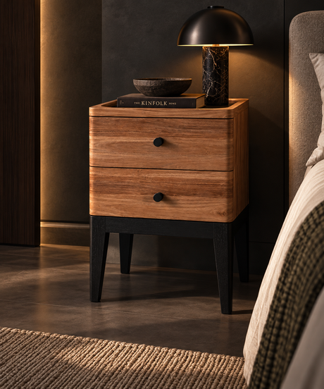 Wooden bedside table with two drawers, round black knobs, a raised tray edge, and tapered black legs.