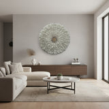 Modern living room with a decorative wall piece, sofa, and coffee table.