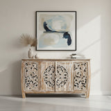 Elegant whitewashed wooden sideboard featuring four intricately carved cabinet doors with floral and medallion detailing, perfect for sophisticated interiors.