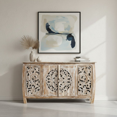 Elegant whitewashed wooden sideboard featuring four intricately carved cabinet doors with floral and medallion detailing, perfect for sophisticated interiors.
