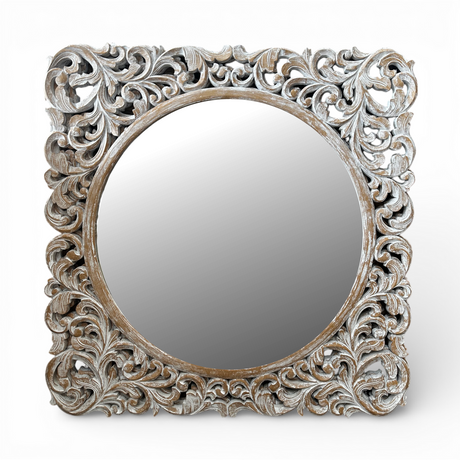 Whitewashed ornate carved wooden wall mirror featuring an intricately hand-carved botanical frame with a distressed natural finish and round mirror centre. This elegant statement mirror adds timeless sophistication to entryways, living rooms, bedrooms, and hallways while complementing coastal, farmhouse, French country, traditional, and luxury interiors.