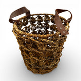 Handcrafted open-weave storage basket with brown leather handles, styled with a soft throw and books for elegant, practical home storage.