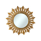 Decorative round wall mirror with an antique gold fleur-inspired sunburst frame featuring elegant leaf-shaped rays and a distressed metallic finish, perfect for adding timeless luxury to any interior.