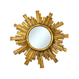 Decorative round wall mirror with an antique gold geometric sunburst frame featuring layered rectangular rays and a distressed metallic finish, perfect for elegant modern and classic interiors.