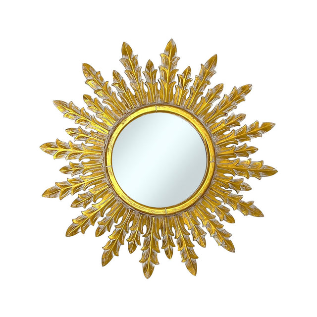 Decorative round wall mirror with an antique gold laurel-inspired sunburst frame featuring elegant branching leaf rays and a distressed metallic finish, creating a timeless luxury statement for any interior.