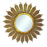 Decorative round wall mirror with an antique gold radiating sunburst frame featuring long textured rays and a distressed metallic finish, adding timeless elegance and a luxurious focal point to any interior.