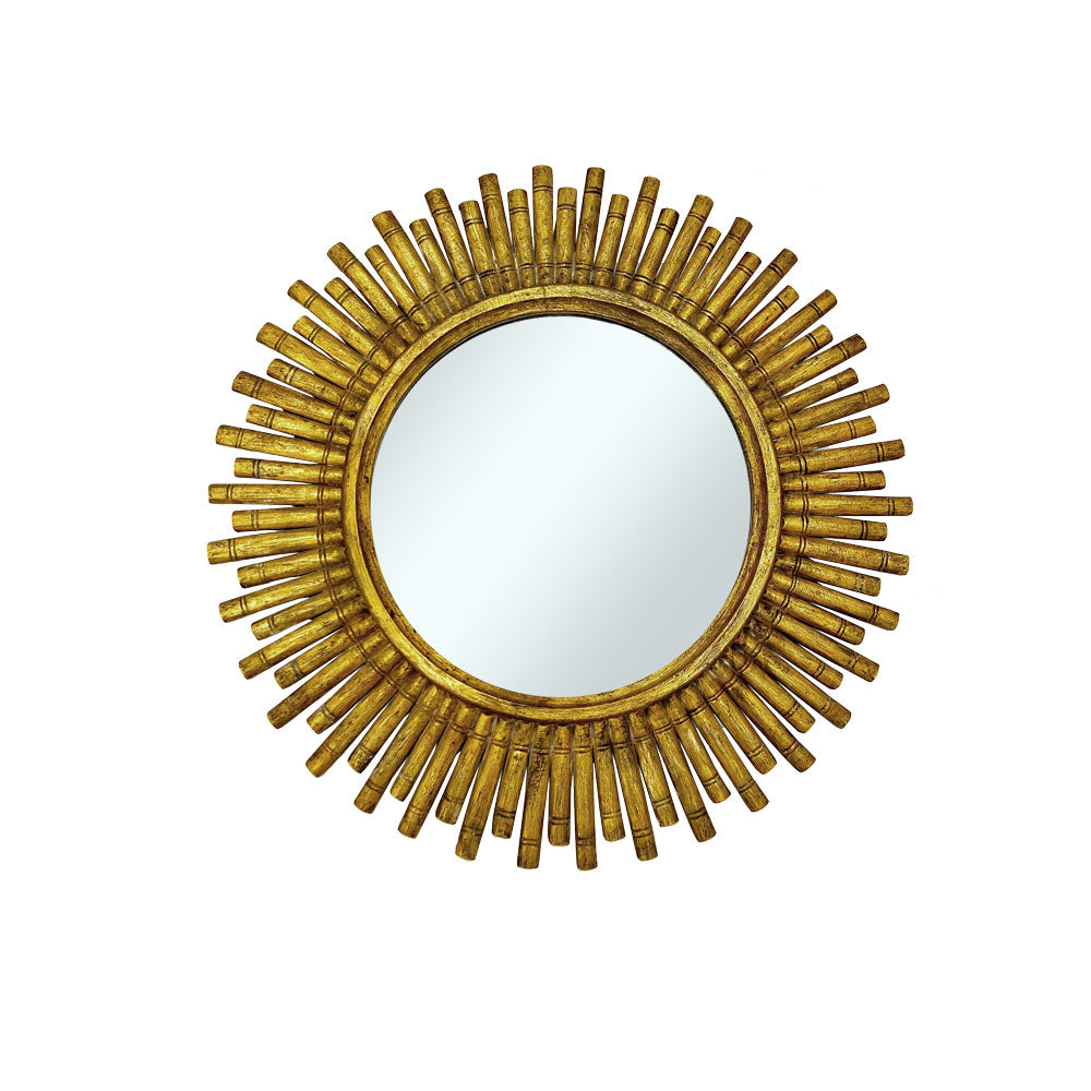 Round wall mirror with an antique gold reed-style sunburst frame featuring evenly spaced textured rays and a distressed metallic finish, adding timeless elegance to any room.