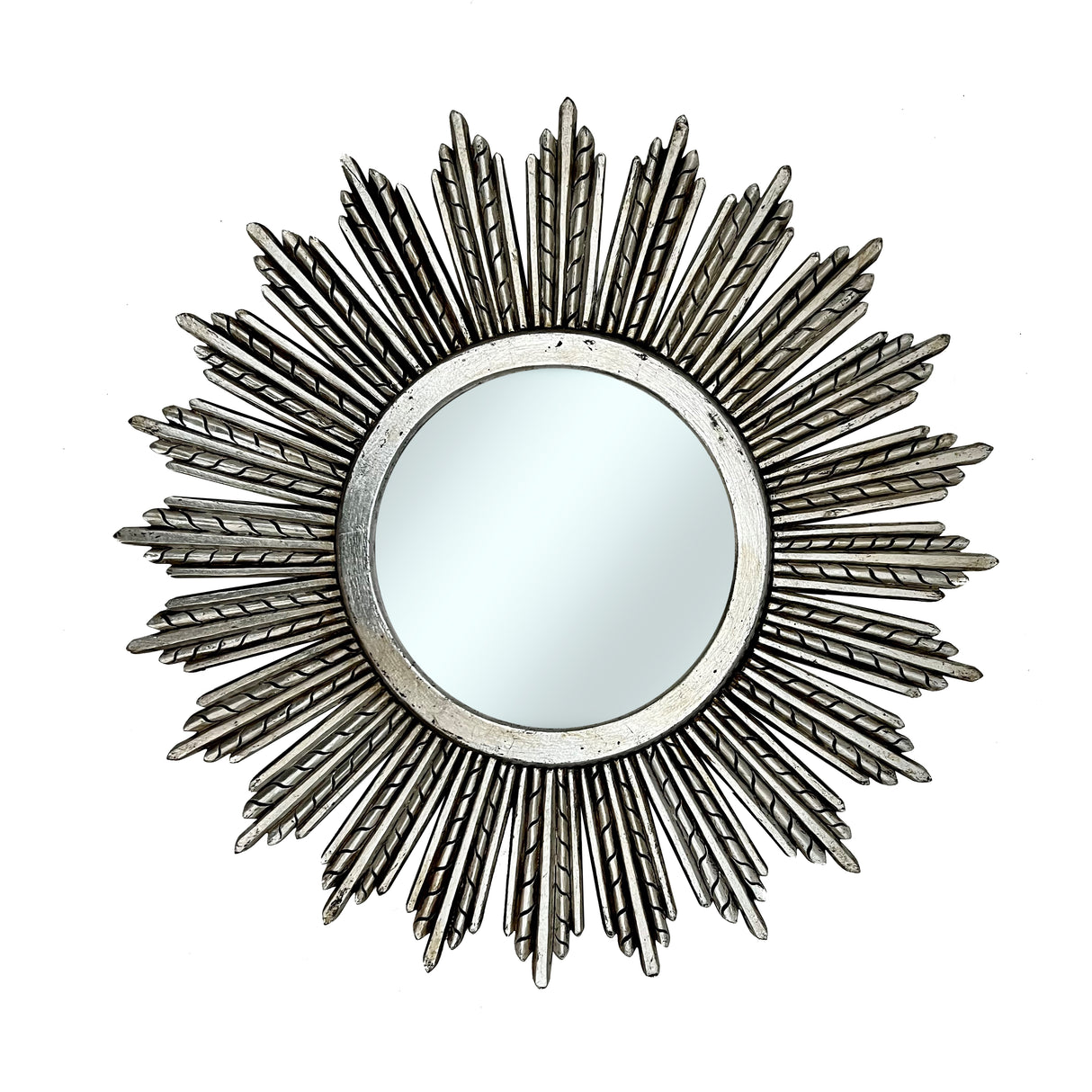 Decorative round wall mirror with an antique silver radiating sunburst frame featuring long textured rays and a distressed metallic finish, creating an elegant statement for classic and contemporary interiors.