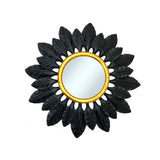 Decorative round wall mirror with a matte black feather-inspired frame and an antique gold inner border, creating a bold contemporary statement with luxurious contrast.