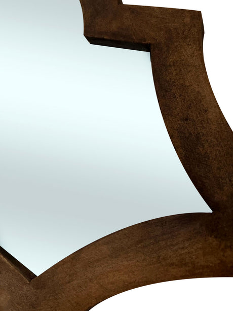 Close-up of a decorative wall mirror featuring a sculptural dark brown wooden frame with smooth curved detailing and a rich natural finish.