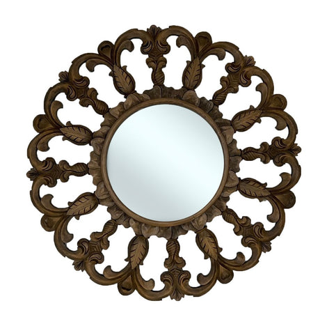 Decorative round wall mirror with a hand-carved dark wood frame featuring intricate floral scrollwork and leaf motifs, bringing timeless elegance and rich natural warmth to classic and traditional interiors.