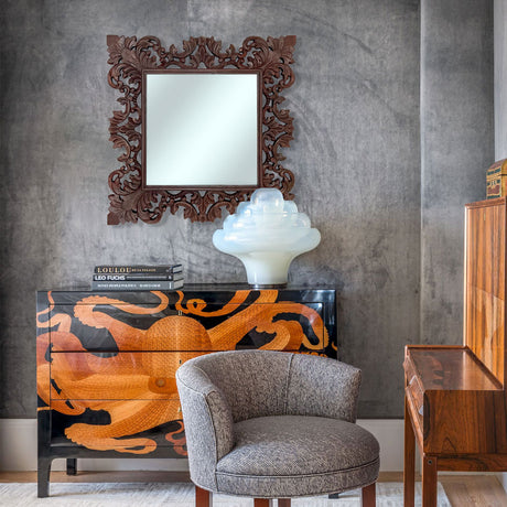 Hand-carved ornate wooden wall mirror with an intricate floral and scrollwork frame in a rich dark wood finish, styled above a statement sideboard to add timeless elegance, artisanal craftsmanship, and classic character to sophisticated interiors.