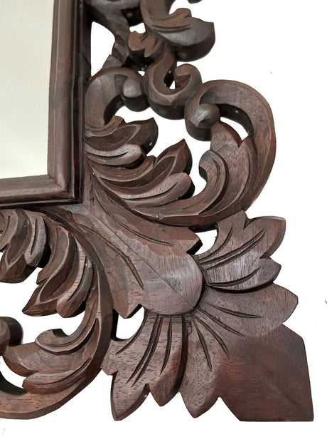 Elegant hand-carved wooden wall mirror featuring intricate Baroque-inspired floral and scroll detailing in a rich dark wood finish, perfect for classic, traditional, and luxury interiors.