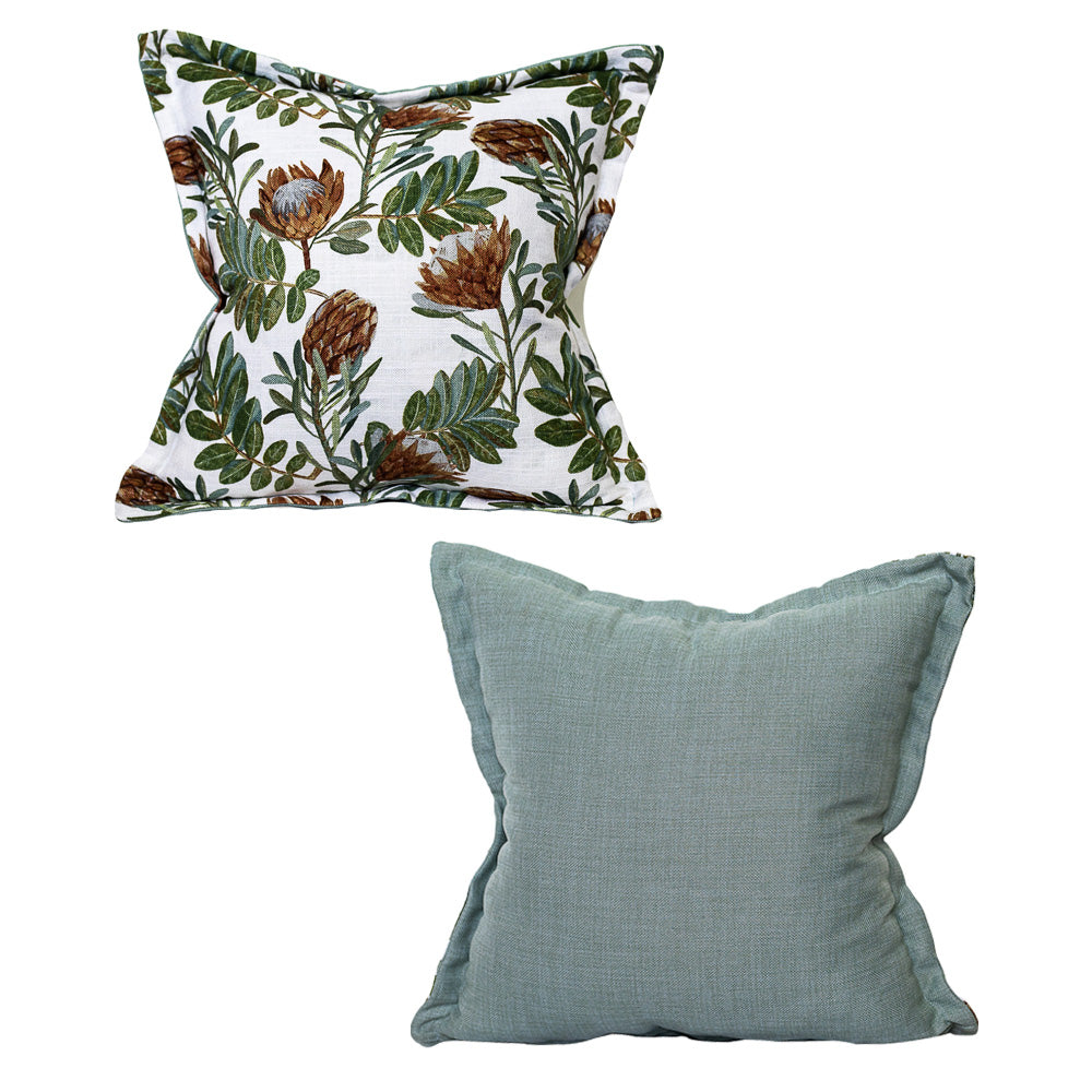 Set of two luxury scatter cushions featuring a South African protea botanical print in sage green, olive, rust, and cream, paired with a plain textured sage green cushion for a fresh, nature-inspired look.
