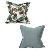 Set of two luxury scatter cushions featuring a South African protea botanical print in sage green, olive, rust, and cream, paired with a plain textured sage green cushion for a fresh, nature-inspired look.