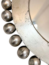 Close-up of a handcrafted silver round wall mirror featuring decorative beaded detailing and a distressed metallic finish, highlighting its elegant craftsmanship and timeless luxury.